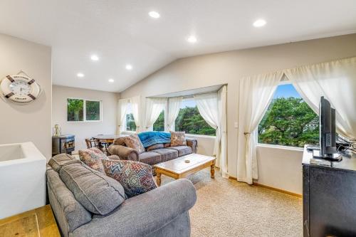 a living room with two couches and a tv at Harvey's Nedonna Nest in Rockaway Beach