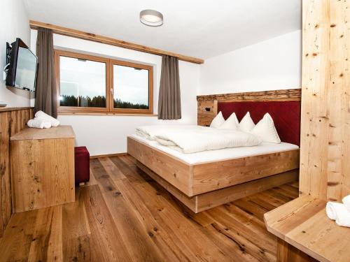 En eller flere senge i et værelse på Chalet Freiblick Kleinhaid, Hollersbach
