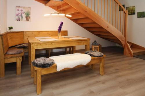 a room with a wooden table with benches and stairs at Chalet Chiemgau, Inzell in Inzell