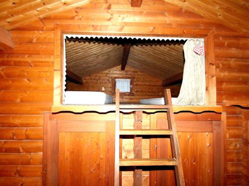 a bedroom in a log cabin with a window at Blockhaus Spreewald, Alt Zauche in Alt Zauche