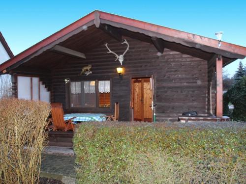 a log cabin with a red roof and a porch at Blockhaus Spreewald, Alt Zauche in Alt Zauche