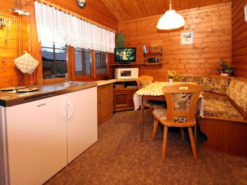 a kitchen with a table and a dining room at Blockhaus Spreewald, Alt Zauche in Alt Zauche
