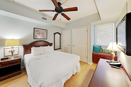 a bedroom with a bed and a ceiling fan at River View Condo A in Wilmington