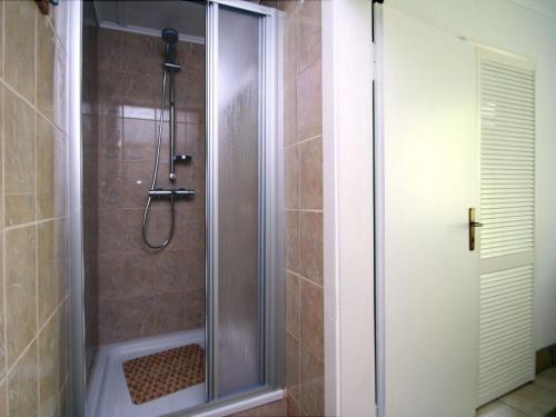a shower with a glass door in a bathroom at Ferienhaus Seeidyll, Teupitz in Teupitz
