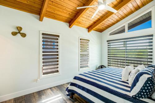 a bedroom with a bed and two windows at Tradewinds Treat in Big Pine Key