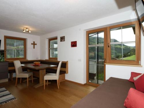 a living room with a table and a cross on the wall at Apartment in Fügenberg near Spieljochbahn in Fügenberg