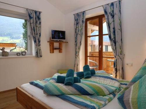A bed or beds in a room at Apartment in Bramberg am Wildkogel with balcony