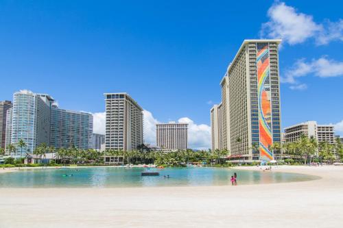 a beach in front of a city with tall buildings at Ilikai Tower 1314 Lagoon View 1BR in Honolulu