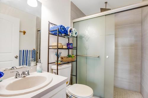 a bathroom with a sink and a toilet and a shower at The Anchor House in Marathon