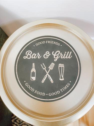 a plate with a bar and grill sign on it at Complexe LIVTremblant by Gestion ELITE - LIV6 in Mont-Tremblant