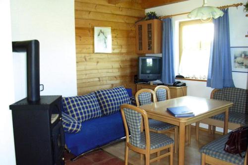 a living room with a couch and a table at Chalet near Kalkalpen National Park in Schlierbach