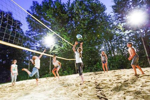 a group of people playing volleyball on a beach at Chalet near Kalkalpen National Park in Schlierbach