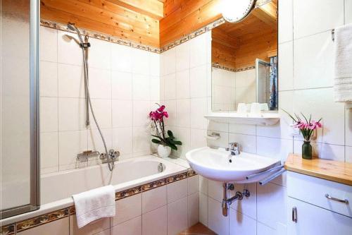 a bathroom with a bath tub and a sink at Chalet near Kalkalpen National Park in Schlierbach