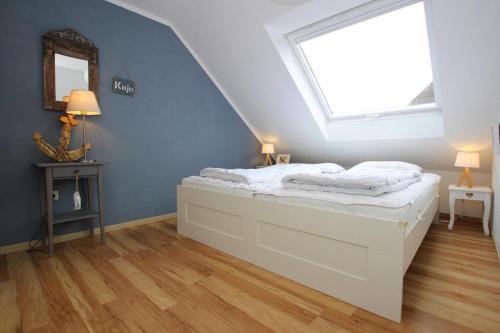 a bedroom with a bed and a window at Apartment, Garding in Garding