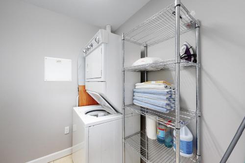 a laundry room with a sink and a drying rack at Waterside Village 406 - Isle of View More in Mexico Beach