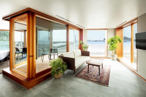 a living room with a couch and a table at HOTEL AO KAMAKURA in Kamakura