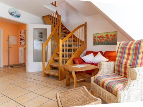 a living room with a couch and a staircase at Apartment in St Peter-Ording in Süderhöft