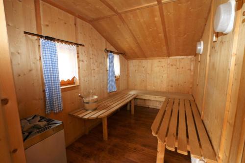 a wooden cabin with a bench and a window at Apartments Joe, Grossarl in Grossarl