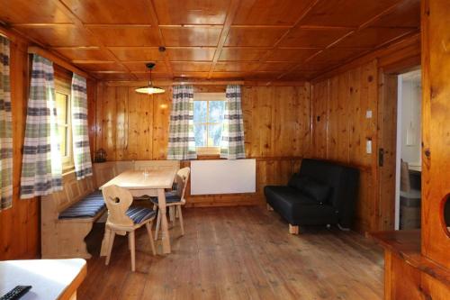 a room with a table and a chair and a couch at Farmhouse in Tobadill with Mountain Views in Tobadill