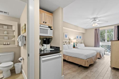 a bedroom with two beds and a bathroom at Salty Escape in Destin