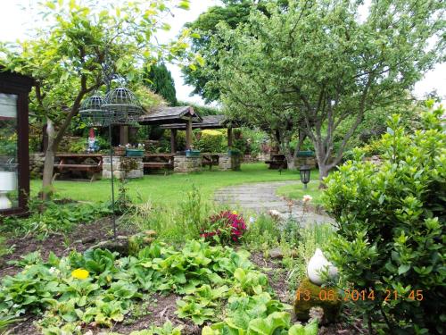 a garden with a gazebo in the background at Ellerby Country Inn in Ellerby