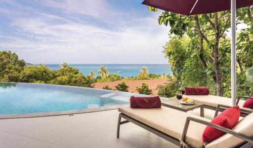 an outdoor patio with a swimming pool and an umbrella at Eranda Pool Spa Villa, Chaweng Koh Samui- SHA Extra Plus in Chaweng