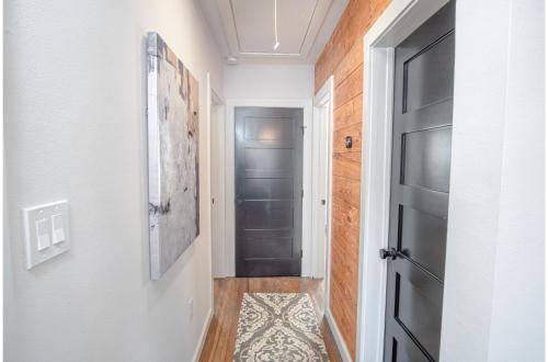 a hallway with a black door and a rug at Dazzling 3 BR2 BA Home Near Downtown Tower Americas in San Antonio