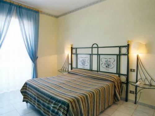 Ένα ή περισσότερα κρεβάτια σε δωμάτιο στο Hotel Scala Greca