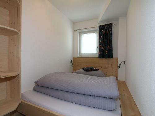 a small bedroom with a bed and a window at Apartment in Hippach near Mayrhofen Ski Area in Hippach