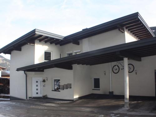 a white building with a black roof at Apartment in Hippach near Mayrhofen Ski Area in Hippach