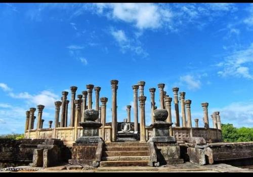 a building with a bunch of pillars on it at ARANI HOMESTAY in Polonnaruwa