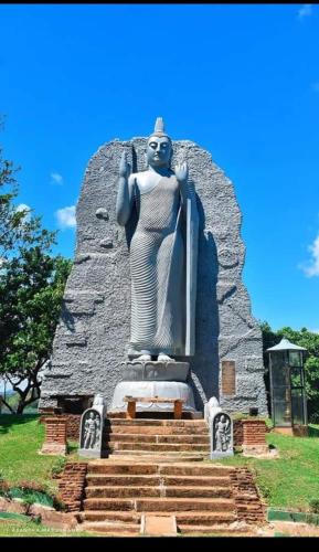 a statue of a woman standing on some stairs at ARANI HOMESTAY in Polonnaruwa