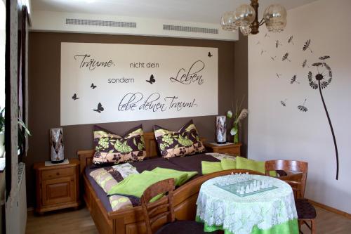 a bedroom with a bed with a table in it at Ferienhaus Planetz in Kaindorf
