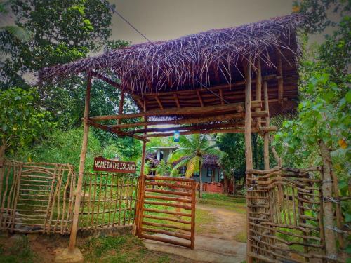 a hut with a fence and a sign in front of it at Home in the Island in Tangalle