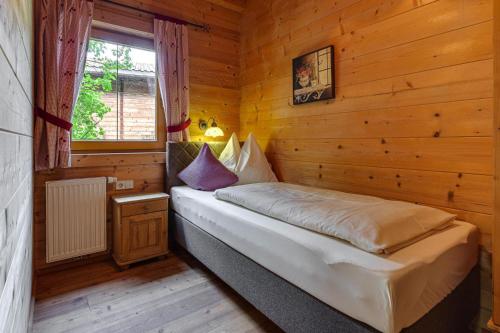 a bedroom with a bed in a wooden cabin at Chalet in Fügen near Spieljochbahn in Fügen