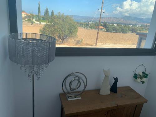 a room with a window with a table and a lamp at The Summer Haven in Polis Chrysochous
