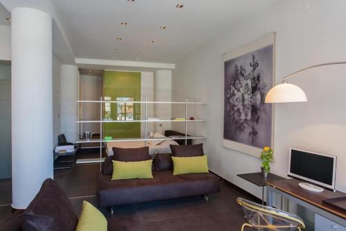 a living room with a couch and a television at Faro Apartments in Chania