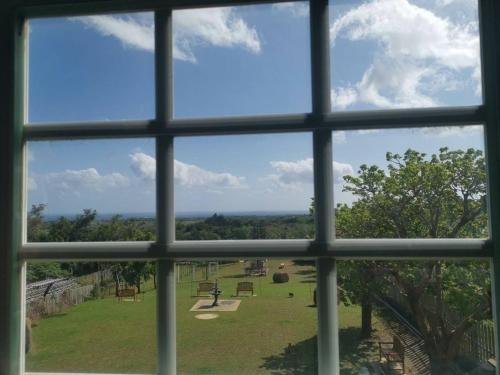 a window view of a park through a window at 墾丁勿忘我城堡莊園 in Hengchun