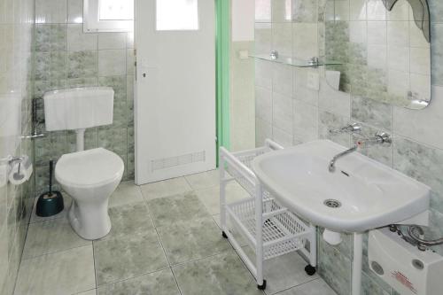 a white bathroom with a sink and a toilet at holiday home, Kolczewo in Kołczewo