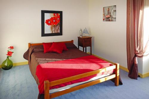 a bedroom with a bed with a red blanket on it at Charming Home near Mont St Michel Bay in Cherrueix