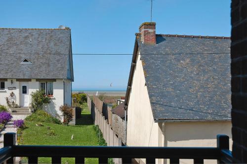 a view from the balcony of a house with a fence at Charming Home near Mont St Michel Bay in Cherrueix