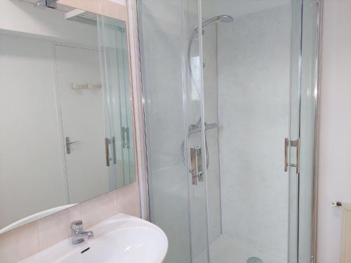 a bathroom with a sink and a glass shower at Chalet in Aber Wrach near Sandy Beaches in Landéda