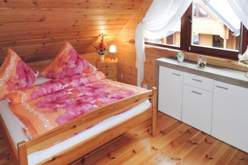 a bedroom with a bed in a wooden room at Holiday homes, Rewal in Rewal
