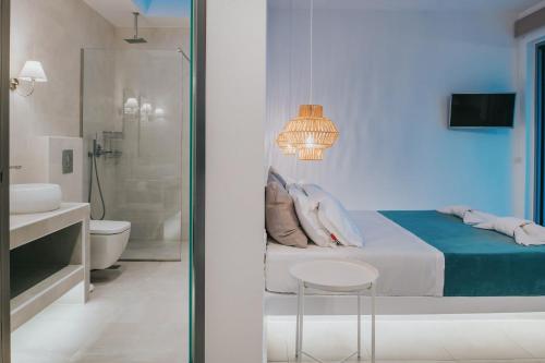 a bathroom with a bed and a toilet and a sink at Zante Fiore Suites in Xirokástellon