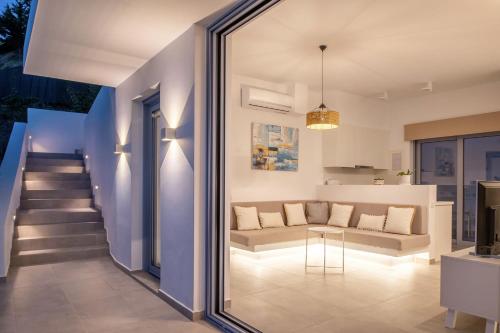 a living room with a couch and a table at Zante Fiore Suites in Xirokástellon