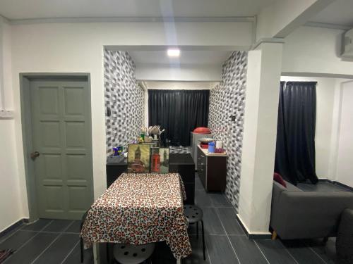 a small room with a table and a chair at SMILEz HOMESTAY B109 AT PD PERDANA CONDO RESORT in Port Dickson