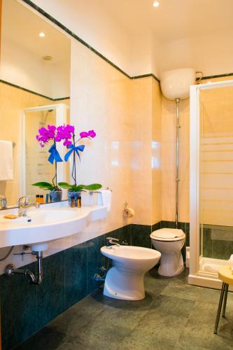 a bathroom with a sink and a toilet at Hotel Dei Pini in Porto Empedocle