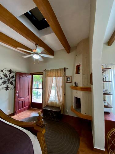 a bedroom with a ceiling fan and a fireplace at Hotel Casa María Félix in Álamos