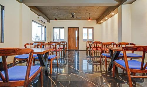 an empty room with wooden tables and chairs at Tripli Hotels Le Shelton in Udaipur