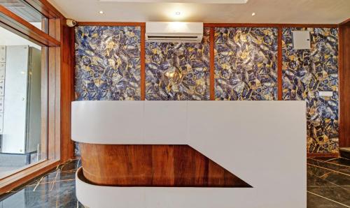a kitchen with a wall covered in wallpaper at Tripli Hotels Le Shelton in Udaipur